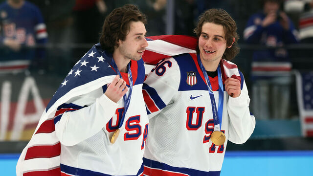 MILAN, ITALY - FEBRUARY 22: Quinn Hughes #43 and Jack Hughes #86 of Team United States celebrate following the Men's Gold Medal match between Canada and the United States on day 16 of the Milano Cortina 2026 Winter Olympic games at Milano Santagiulia Ice Hockey Arena on February 22, 2026 in Milan, Italy. The United States defeated Canada 2-1 in overtime.