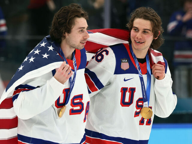 MILAN, ITALY - FEBRUARY 22: Quinn Hughes #43 and Jack Hughes #86 of Team United States celebrate following the Men's Gold Medal match between Canada and the United States on day 16 of the Milano Cortina 2026 Winter Olympic games at Milano Santagiulia Ice Hockey Arena on February 22, 2026 in Milan, Italy. The United States defeated Canada 2-1 in overtime.