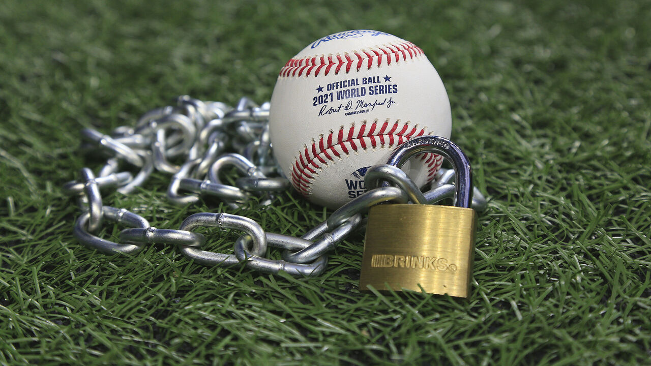 Atlanta, GA - January 09: An Official Rawlings Major League baseball sits with a glove, lock and chain to represent the lockout between Major League Baseball (MLB) and the Major League Baseball Players Association (MLBPA) on January 09, 2022 in Atlanta, Georgia.