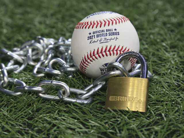 Atlanta, GA - January 09: An Official Rawlings Major League baseball sits with a glove, lock and chain to represent the lockout between Major League Baseball (MLB) and the Major League Baseball Players Association (MLBPA) on January 09, 2022 in Atlanta, Georgia.