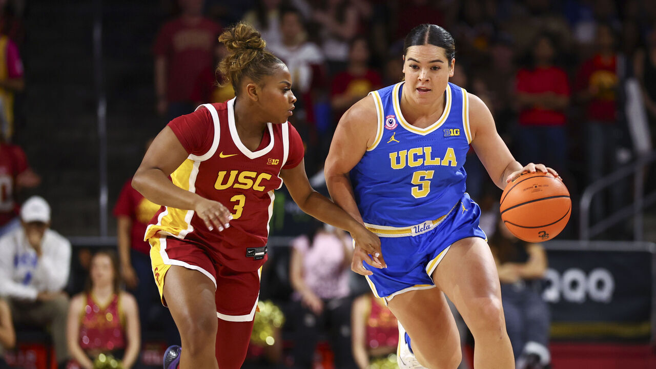 LOS ANGELES, CALIFORNIA - MARCH 1: Charlisse Leger-Walker #5 of the UCLA Bruins handles the ball as Londynn Jones #3 of the USC Trojans defends during the first half at Galen Center on March 1, 2026 in Los Angeles, California.