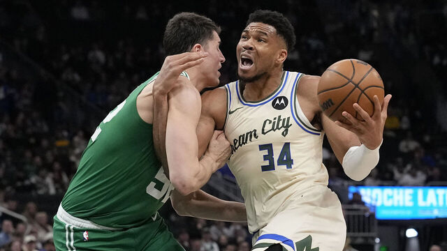 MILWAUKEE, WISCONSIN - MARCH 02: Giannis Antetokounmpo #34 of the Milwaukee Bucks dribbles the ball against Luka Garza #52 of the Boston Celtics during the second quarter at Fiserv Forum on March 02, 2026 in Milwaukee, Wisconsin.