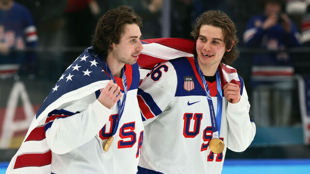 MILAN, ITALY - FEBRUARY 22: Quinn Hughes #43 and Jack Hughes #86 of Team United States celebrate following the Men's Gold Medal match between Canada and the United States on day 16 of the Milano Cortina 2026 Winter Olympic games at Milano Santagiulia Ice Hockey Arena on February 22, 2026 in Milan, Italy. The United States defeated Canada 2-1 in overtime.