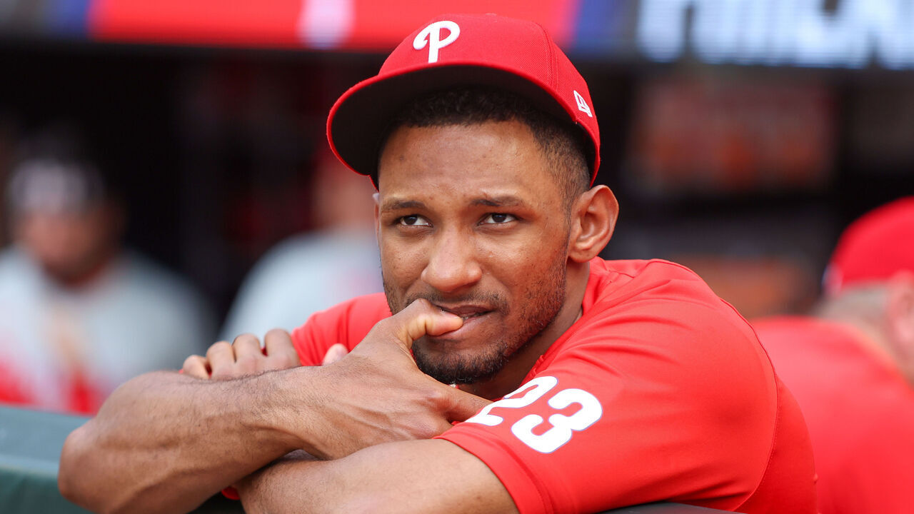 ATLANTA, GEORGIA - JUNE 28: Johan Rojas #23 of the Philadelphia Phillies bites his nails in the dugout before a game against the Atlanta Braves at Truist Park on June 28, 2025 in Atlanta, Georgia.