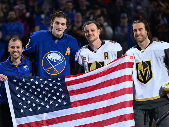 BUFFALO, NEW YORK - MARCH 3: (L-R) Buffalo Sabres team masseuse Brett Crompton, Tage Thompson #72 of the Buffalo Sabres, Jack Eichel #9 and Noah Hanifin #15 of the Vegas Golden Knights hold up a U.S. flag as they are recognized before the game, celebrating Team USA Men's Olympic gold medal victory, before the NHL game at KeyBank Center on March 3, 2026 in Buffalo, New York.