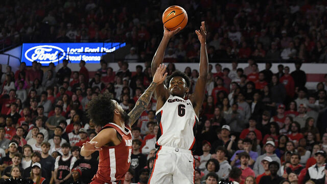 ATHENS, GA - MARCH 03: Forward Kanon Catchings #6 of the Georgia Bulldogs shoots the ball as guard Houston Mallette #95 of the Alabama Crimson Tide defends during the college basketball game between the Alabama Crimson Tide and the Georgia Bulldogs on March 03, 2026, at Stegeman Coliseum in Athens, GA.