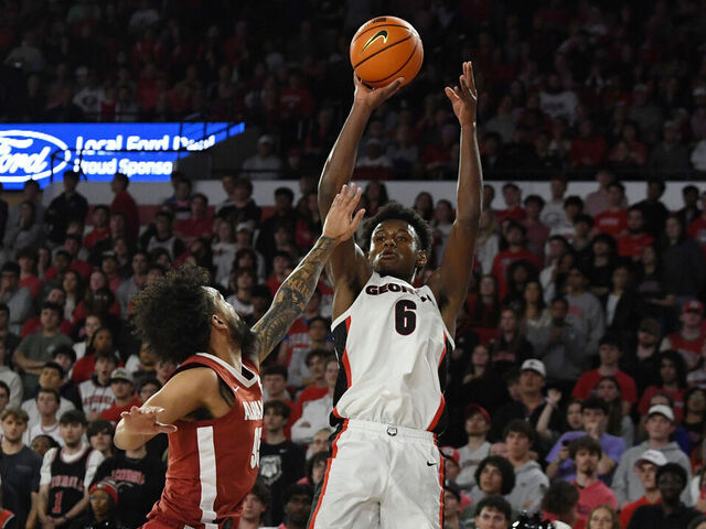 ATHENS, GA - MARCH 03: Forward Kanon Catchings #6 of the Georgia Bulldogs shoots the ball as guard Houston Mallette #95 of the Alabama Crimson Tide defends during the college basketball game between the Alabama Crimson Tide and the Georgia Bulldogs on March 03, 2026, at Stegeman Coliseum in Athens, GA.
