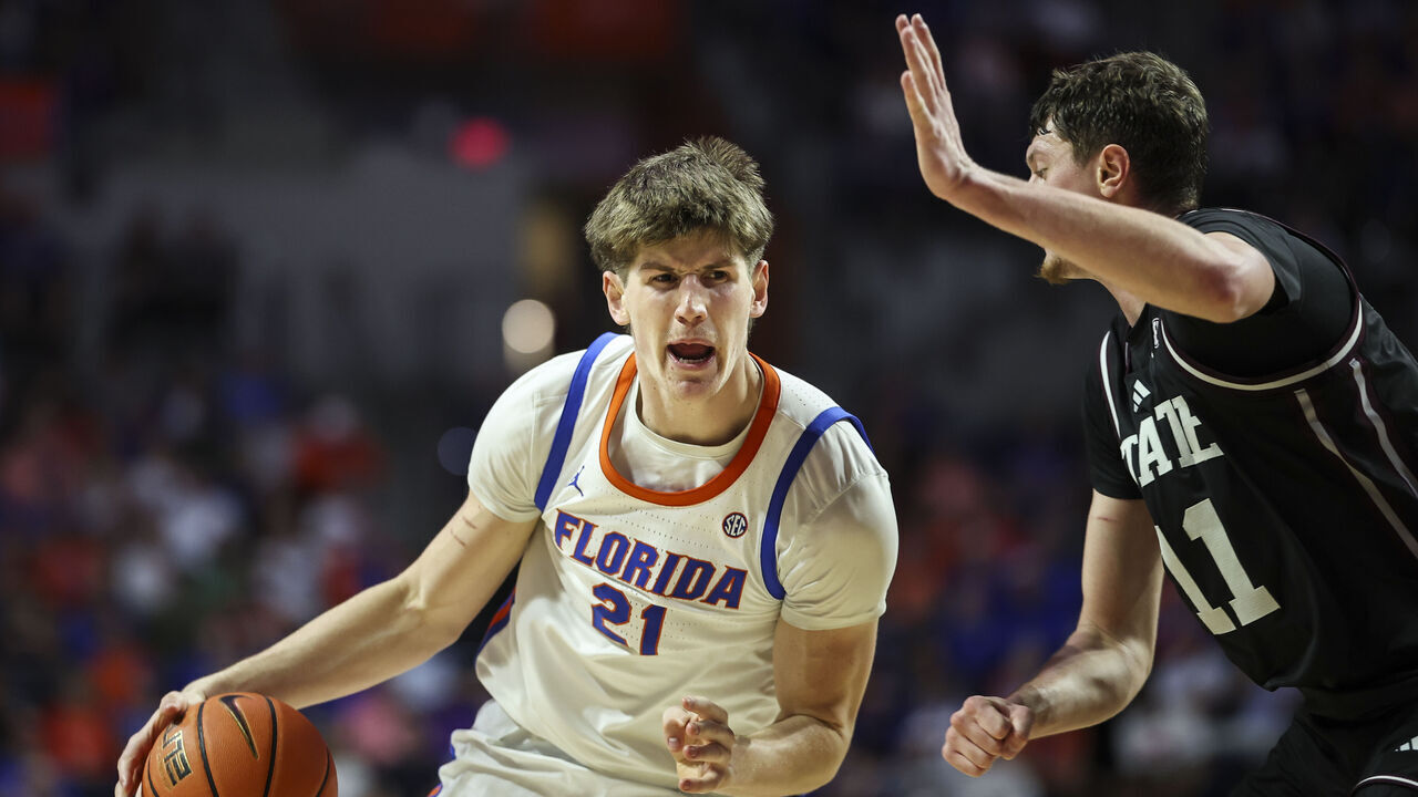 GAINESVILLE, FLORIDA - MARCH 03: Alex Condon #21 of the Florida Gators dribbles the ball to the basket against Sergej Macura #11 of the Mississippi State Bulldogs during the first half of the game at the Stephen C. O'Connell Center on March 03, 2026 in Gainesville, Florida.