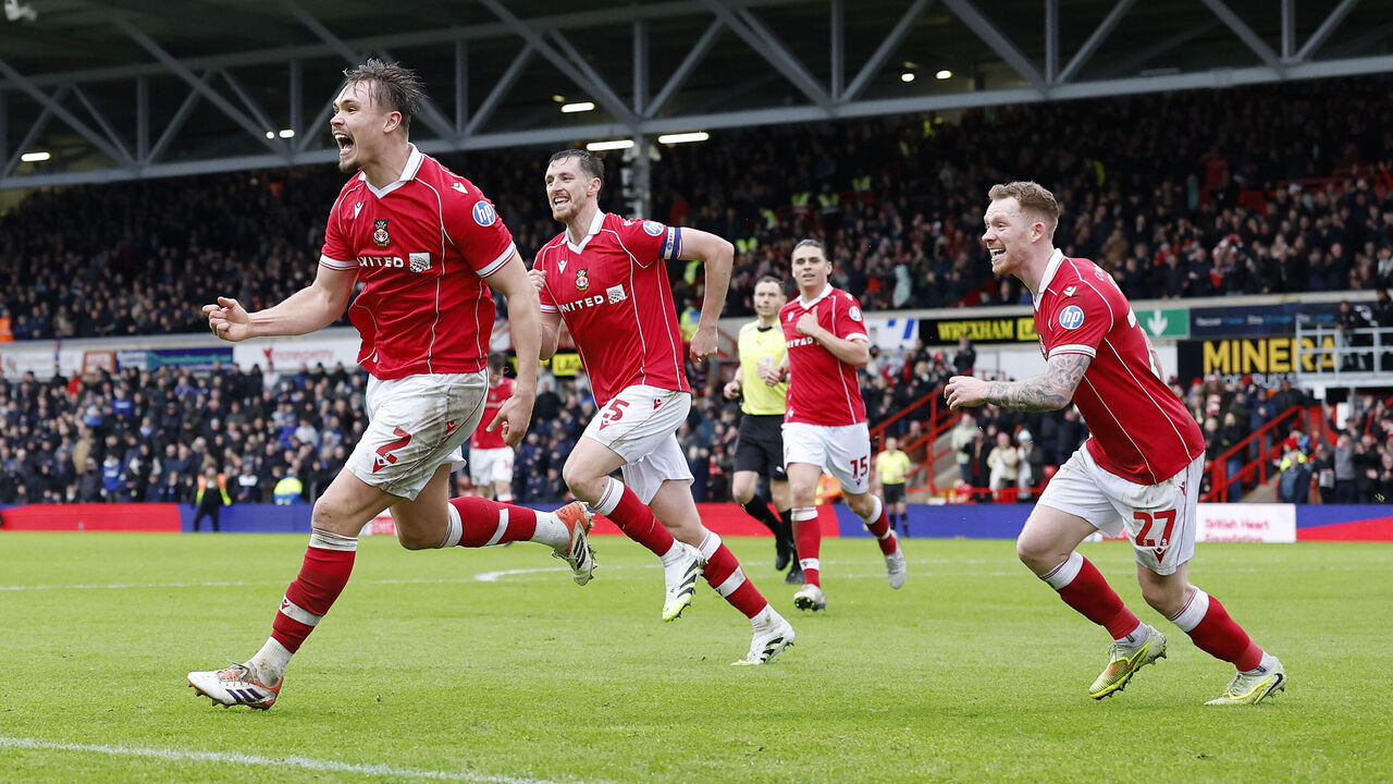 Wrexham's Callum Doyle (left) celebrates scoring their side's fourth goal during the Sky Bet Championship match at the SToK Racecourse, Wrexham. Picture date: Saturday February 21, 2026.