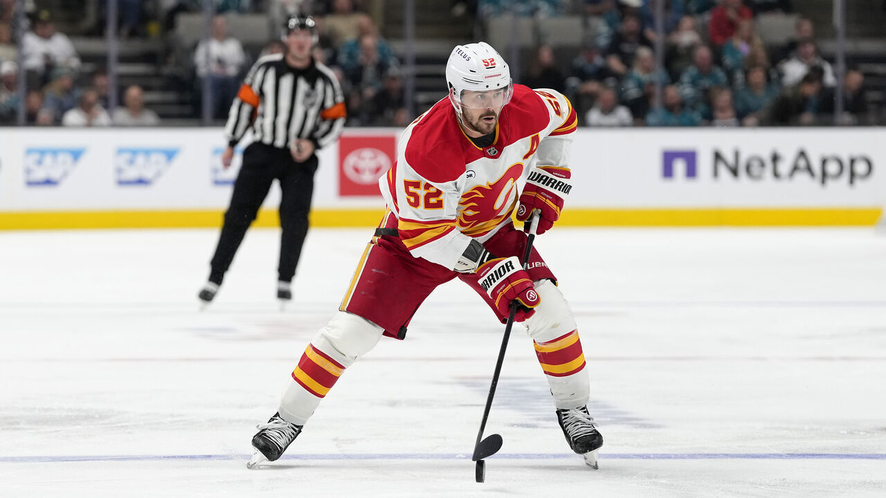 SAN JOSE, CALIFORNIA - FEBRUARY 26: MacKenzie Weegar #52 of the Calgary Flames skates with the puck against the San Jose Sharks in the third period of an NHL hockey game at SAP Center on February 26, 2026 in San Jose, California.