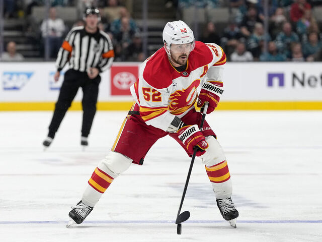 SAN JOSE, CALIFORNIA - FEBRUARY 26: MacKenzie Weegar #52 of the Calgary Flames skates with the puck against the San Jose Sharks in the third period of an NHL hockey game at SAP Center on February 26, 2026 in San Jose, California.