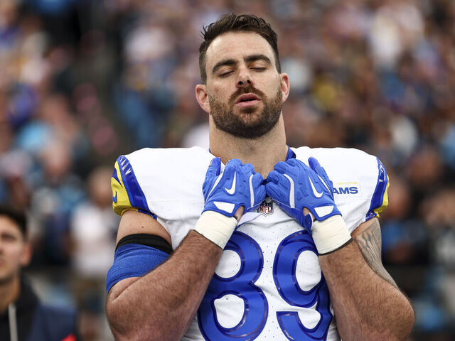 CHARLOTTE, NORTH CAROLINA - JANUARY 10: Tyler Higbee #89 of the Los Angeles Rams stands on the sidelines during the national anthem prior to an NFL wild card playoff football game against the Carolina Panthers at Bank of America Stadium on January 10, 2026 in Charlotte, North Carolina.