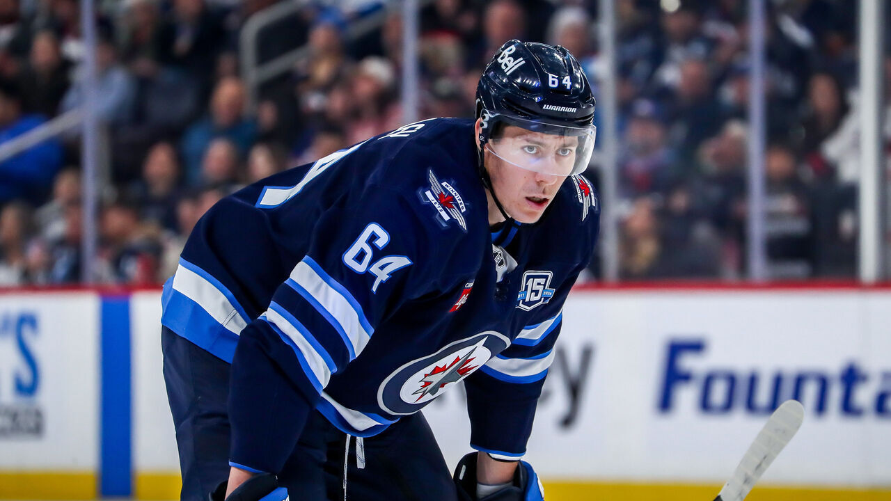 WINNIPEG, CANADA - MARCH 3: Logan Stanley #64 of the Winnipeg Jets looks on during a first period stoppage in play against the Chicago Blackhawks at the Canada Life Centre on March 3, 2026 in Winnipeg, Manitoba, Canada. The Jets defeated the Hawks 3-2 in overtime.