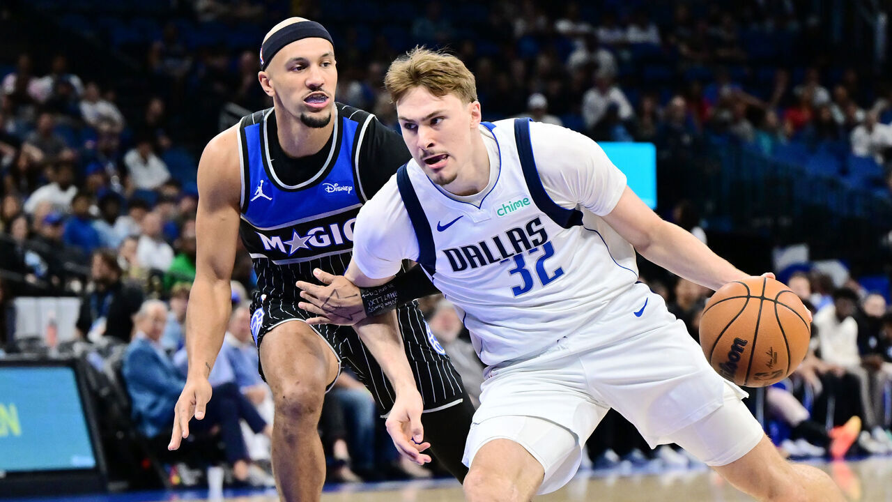 ORLANDO, FLORIDA - MARCH 05: Cooper Flagg #32 of the Dallas Mavericks drives to the basket against Jalen Suggs #4 of the Orlando Magic in the first half of a game at Kia Center on March 05, 2026 in Orlando, Florida.