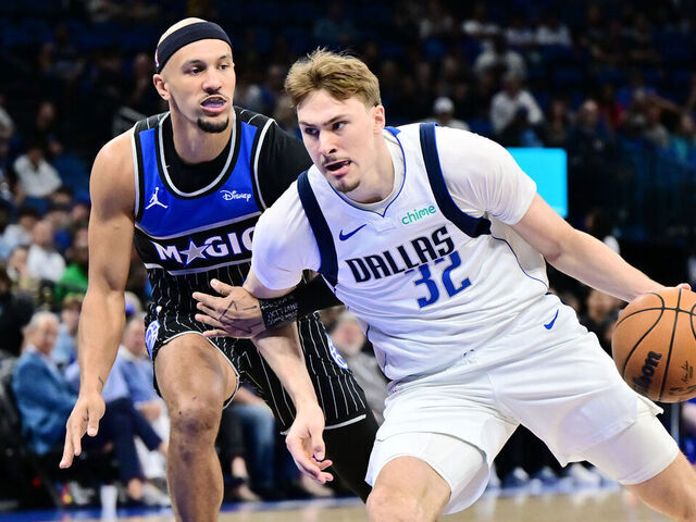 ORLANDO, FLORIDA - MARCH 05: Cooper Flagg #32 of the Dallas Mavericks drives to the basket against Jalen Suggs #4 of the Orlando Magic in the first half of a game at Kia Center on March 05, 2026 in Orlando, Florida.