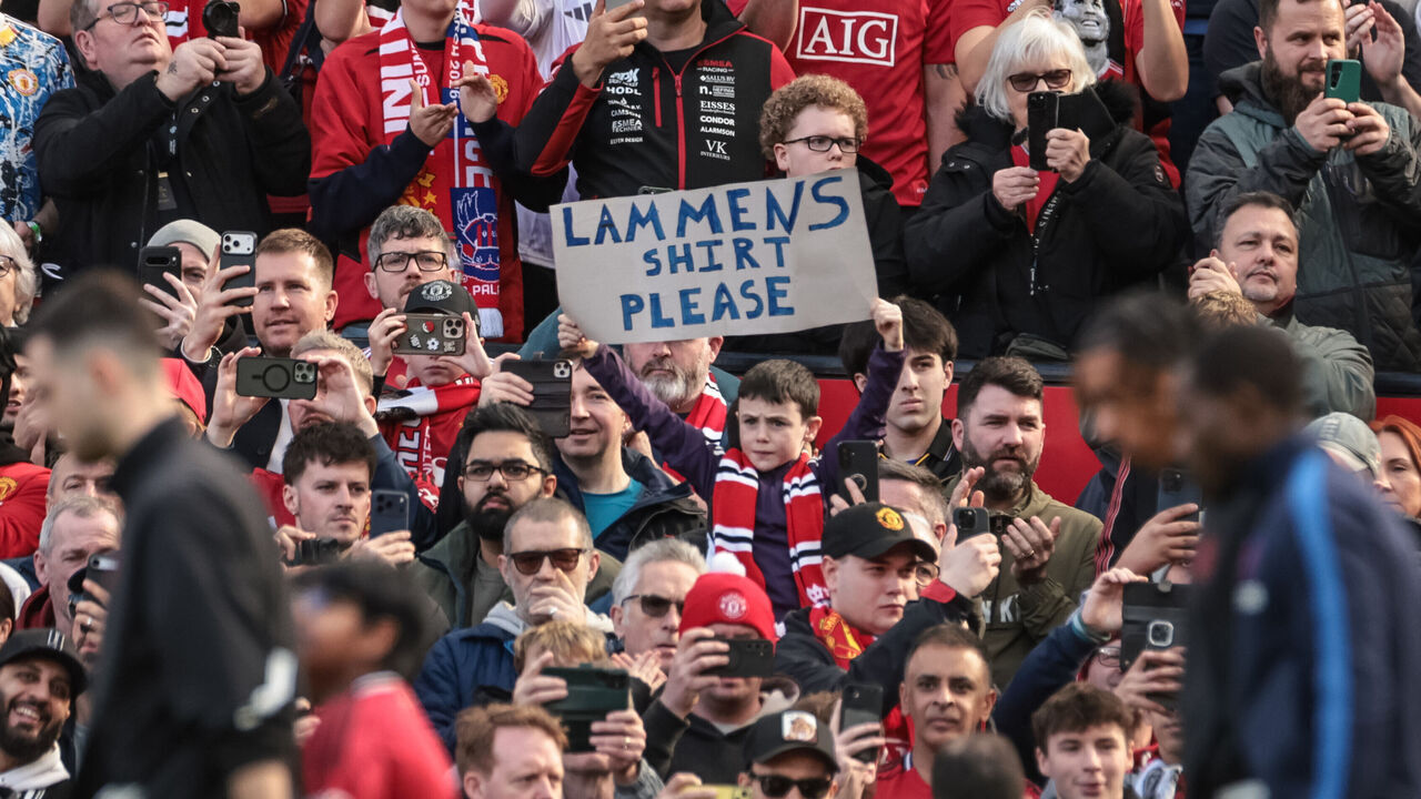 A young United fan holds up a banner for Manchester United goalkeeper Senne Lammens during the Premier League match between Manchester United and Crystal Palace at Old Trafford in Manchester, United Kingdom, on March 1, 2026.