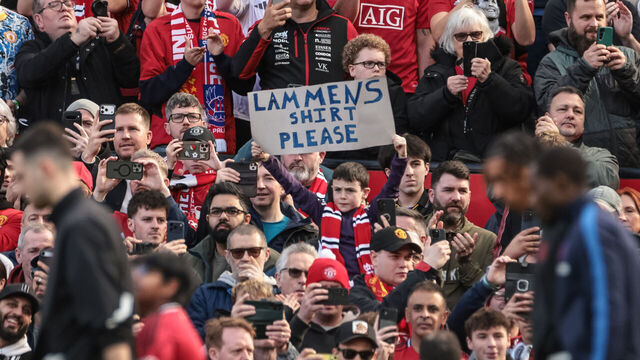 A young United fan holds up a banner for Manchester United goalkeeper Senne Lammens during the Premier League match between Manchester United and Crystal Palace at Old Trafford in Manchester, United Kingdom, on March 1, 2026.
