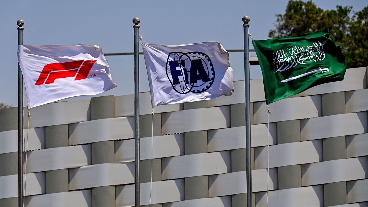 The flags of the Formula One (L), the Federation Internationale de l'Automobile (C) and Saudi Arabia (R) wave ahead of the third practice session ahead of the 2022 Saudi Arabia Formula One Grand Prix at the Jeddah Corniche Circuit on March 26, 2022.
