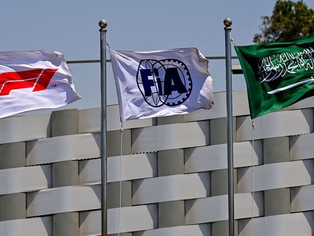 The flags of the Formula One (L), the Federation Internationale de l'Automobile (C) and Saudi Arabia (R) wave ahead of the third practice session ahead of the 2022 Saudi Arabia Formula One Grand Prix at the Jeddah Corniche Circuit on March 26, 2022.