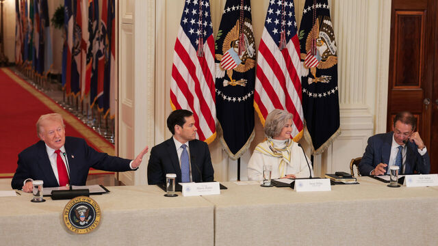 WASHINGTON, DC - MARCH 06: U.S. President Donald Trump (L) gestures as former head coach Nick Saban (R) speaks alongside U.S. Secretary of State Marco Rubio and White House Chief of Staff Susie Wiles during a roundtable discussion on college sports in the East Room of the White House on March 06, 2026 in Washington, DC. The Trump administration held the roundtable titled "Saving College Sports" with leaders from the Power Four conferences, media executives and former coaches.
