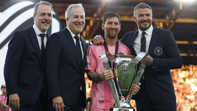 FORT LAUDERDALE, FLORIDA - DECEMBER 06: José Mas, Jorge Mas and Sir David Beckham, co-owners of Inter Miami CF pose with the Champion's trophy next to Lionel Messi #10 after winning the Audi 2025 MLS Cup Final match between Inter Miami CF and Vancouver Whitecaps FC at Chase Stadium on December 06, 2025 in Fort Lauderdale, Florida.