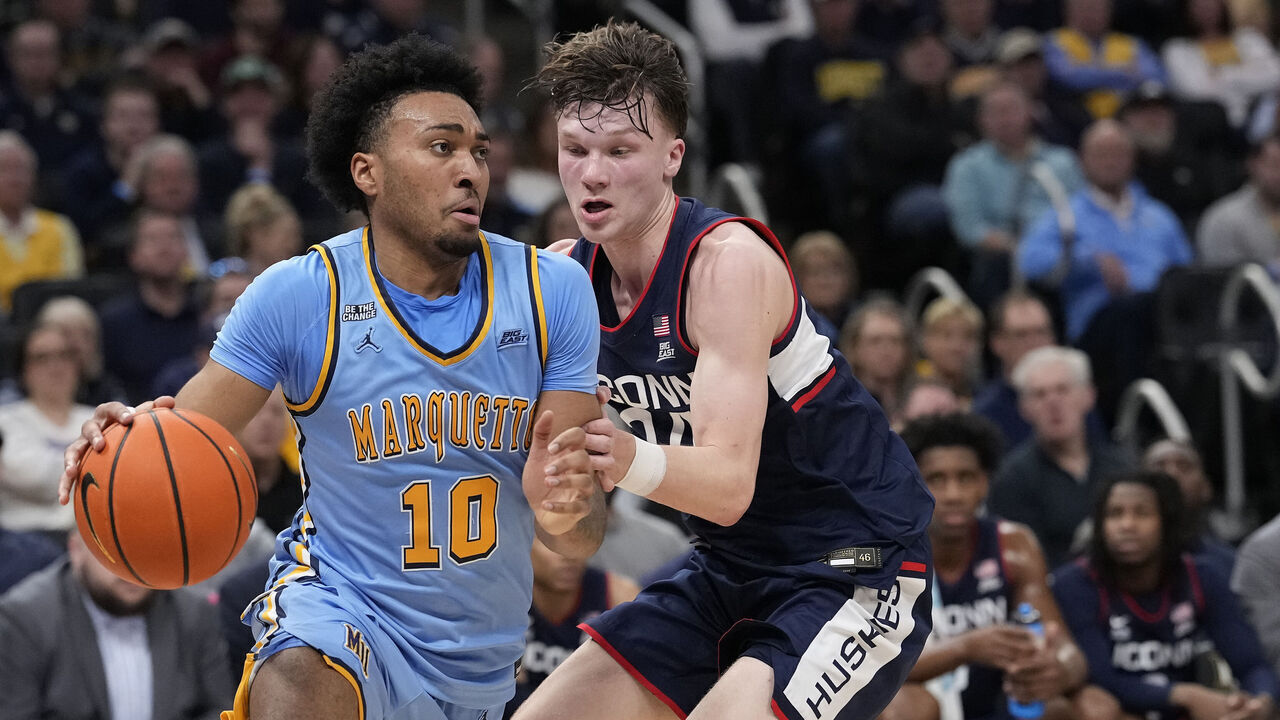 MILWAUKEE, WISCONSIN - MARCH 07: Adrien Stevens #10 of the Marquette Golden Eagles dribbles the ball against Braylon Mullins #24 of the Connecticut Huskies during the first half at Fiserv Forum on March 07, 2026 in Milwaukee, Wisconsin.