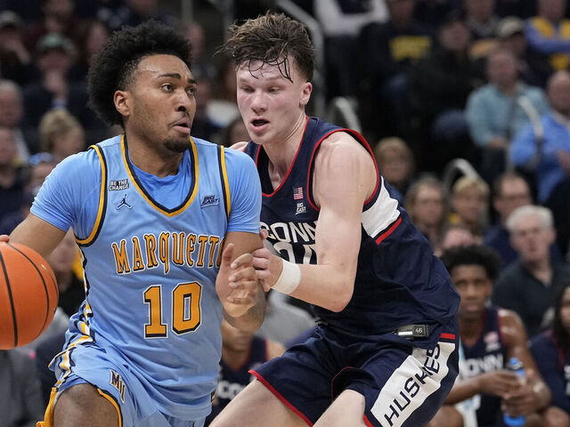 MILWAUKEE, WISCONSIN - MARCH 07: Adrien Stevens #10 of the Marquette Golden Eagles dribbles the ball against Braylon Mullins #24 of the Connecticut Huskies during the first half at Fiserv Forum on March 07, 2026 in Milwaukee, Wisconsin.