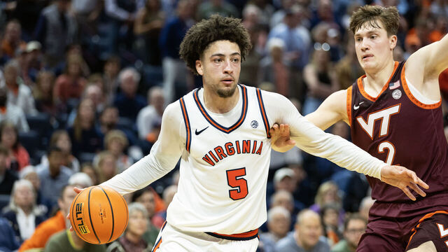 CHARLOTTESVILLE, VIRGINIA - MARCH 7: Sam Lewis #5 of the Virginia Cavaliers drives past Jaden Schutt #2 of the Virginia Tech Hokies in the second half during a game at John Paul Jones Arena on March 7, 2026 in Charlottesville, Virginia.