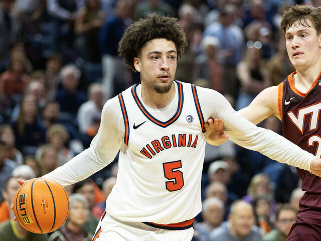CHARLOTTESVILLE, VIRGINIA - MARCH 7: Sam Lewis #5 of the Virginia Cavaliers drives past Jaden Schutt #2 of the Virginia Tech Hokies in the second half during a game at John Paul Jones Arena on March 7, 2026 in Charlottesville, Virginia.
