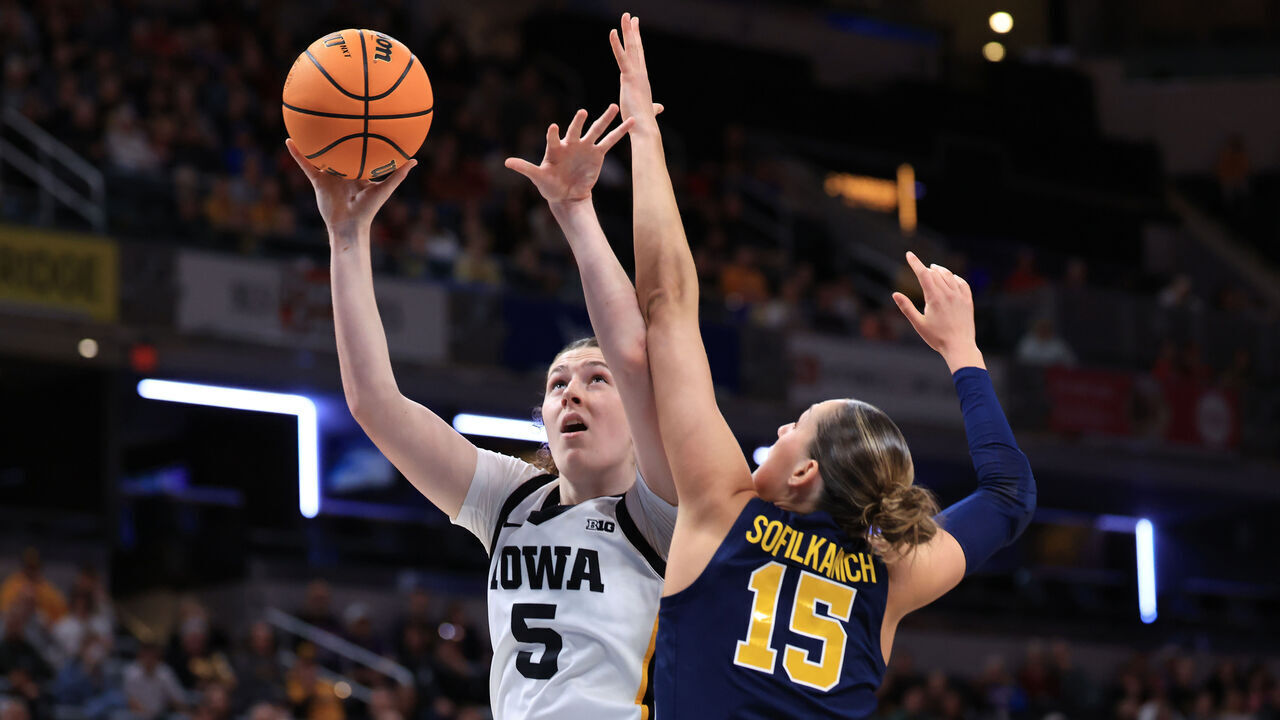 INDIANAPOLIS, INDIANA - MARCH 07: Ava Heiden #5 of the Iowa Hawkeyes takes a shot over Ashley Sofilkanich #15 of the Michigan Wolverines during the first half of the Big Ten Women's Basketball Tournament semifinals game at Gainbridge Fieldhouse on March 07, 2026 in Indianapolis, Indiana.