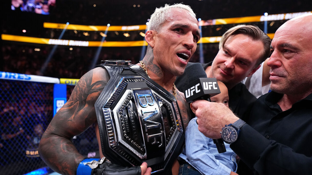 LAS VEGAS, NEVADA - MARCH 07: (R-L) Joe Rogan interviews Charles Oliveira of Brazil following the BMF Championship fight during the UFC 326 event at T-Mobile Arena on March 07, 2026 in Las Vegas, Nevada.