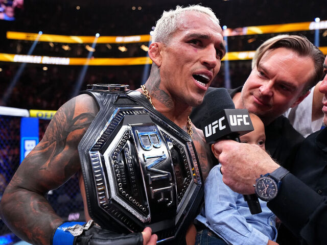 LAS VEGAS, NEVADA - MARCH 07: (R-L) Joe Rogan interviews Charles Oliveira of Brazil following the BMF Championship fight during the UFC 326 event at T-Mobile Arena on March 07, 2026 in Las Vegas, Nevada.