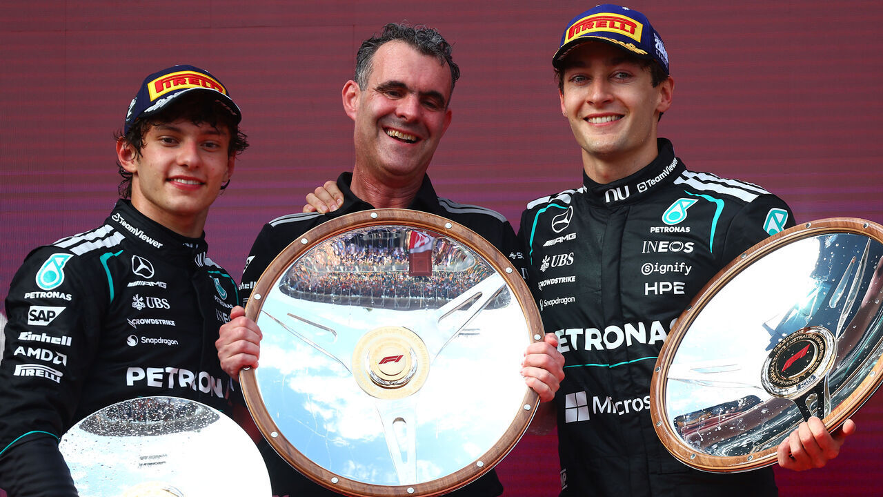 MELBOURNE, AUSTRALIA - MARCH 08: Race winner George Russell of Great Britain and Mercedes AMG Petronas F1 Team Second placed Andrea Kimi Antonelli of Italy and Mercedes AMG Petronas F1 Team and Hywel Thomas, Managing director of Mercedes AMG High Performance Powertrains on the podium with the trophies during the F1 Grand Prix of Australia at Albert Park Grand Prix Circuit on March 08, 2026 in Melbourne, Australia.