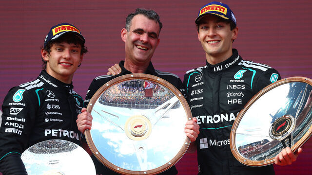 MELBOURNE, AUSTRALIA - MARCH 08: Race winner George Russell of Great Britain and Mercedes AMG Petronas F1 Team Second placed Andrea Kimi Antonelli of Italy and Mercedes AMG Petronas F1 Team and Hywel Thomas, Managing director of Mercedes AMG High Performance Powertrains on the podium with the trophies during the F1 Grand Prix of Australia at Albert Park Grand Prix Circuit on March 08, 2026 in Melbourne, Australia.