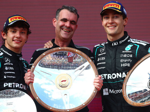 MELBOURNE, AUSTRALIA - MARCH 08: Race winner George Russell of Great Britain and Mercedes AMG Petronas F1 Team Second placed Andrea Kimi Antonelli of Italy and Mercedes AMG Petronas F1 Team and Hywel Thomas, Managing director of Mercedes AMG High Performance Powertrains on the podium with the trophies during the F1 Grand Prix of Australia at Albert Park Grand Prix Circuit on March 08, 2026 in Melbourne, Australia.