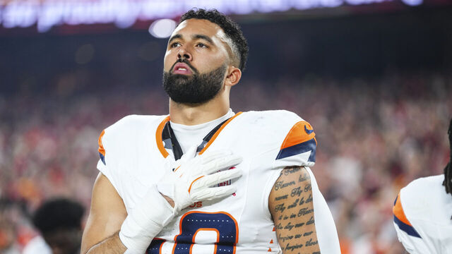 KANSAS CITY, MO - DECEMBER 25: Justin Strnad #40 of the Denver Broncos looks on from the sideline during the national anthem prior to an NFL football game against the Kansas City Chiefs at GEHA Field at Arrowhead Stadium on December 25, 2025 in Kansas City, Missouri.