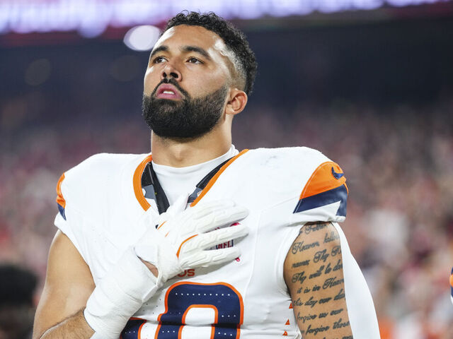 KANSAS CITY, MO - DECEMBER 25: Justin Strnad #40 of the Denver Broncos looks on from the sideline during the national anthem prior to an NFL football game against the Kansas City Chiefs at GEHA Field at Arrowhead Stadium on December 25, 2025 in Kansas City, Missouri.