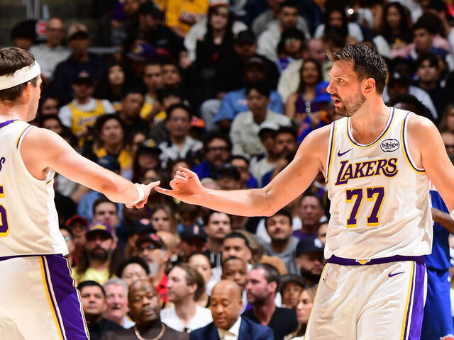 LOS ANGELES, CA - MARCH 8: Austin Reaves #15 and Luka Doncic #77 of the Los Angeles Lakers high five during the game against the New York Knicks on March 8, 2026 at Crypto.Com Arena in Los Angeles, California. NOTE TO USER: User expressly acknowledges and agrees that, by downloading and/or using this Photograph, user is consenting to the terms and conditions of the Getty Images License Agreement. Mandatory Copyright Notice: Copyright 2026 NBAE