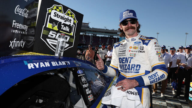 AVONDALE, ARIZONA - MARCH 08: Ryan Blaney, driver of the #12 Dent Wizard Ford, poses with the winner sticker on his car in victory lane after winning the NASCAR Cup Series Straight Talk Wireless 500 at Phoenix Raceway on March 08, 2026 in Avondale, Arizona.