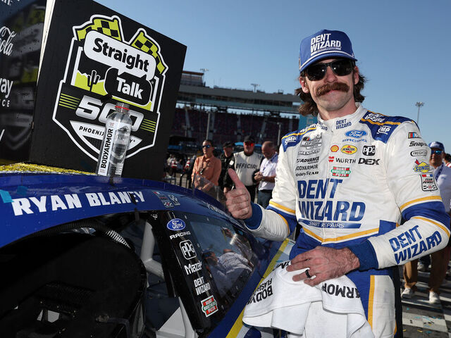 AVONDALE, ARIZONA - MARCH 08: Ryan Blaney, driver of the #12 Dent Wizard Ford, poses with the winner sticker on his car in victory lane after winning the NASCAR Cup Series Straight Talk Wireless 500 at Phoenix Raceway on March 08, 2026 in Avondale, Arizona.
