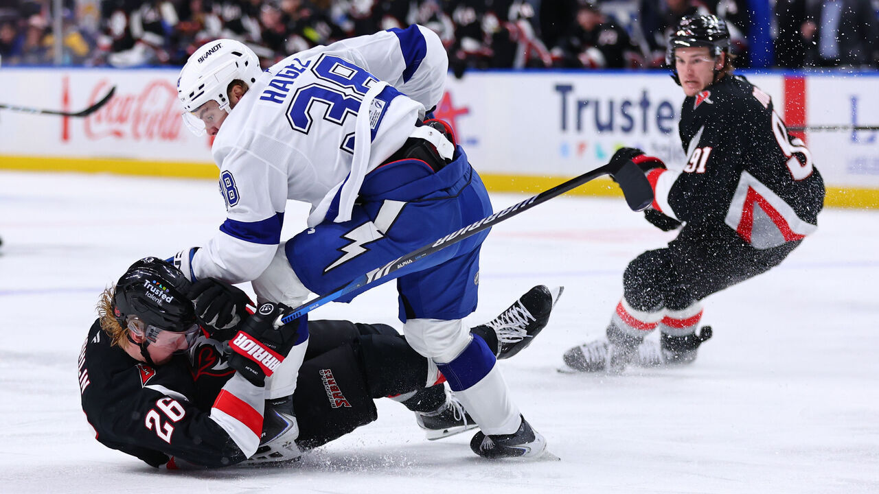 BUFFALO, NEW YORK - MARCH 08: Rasmus Dahlin #26 of the Buffalo Sabres is upset by Brandon Hagel #38 of the Tampa Bay Lightning during an NHL game on March 08, 2026 at KeyBank Center in Buffalo, New York.