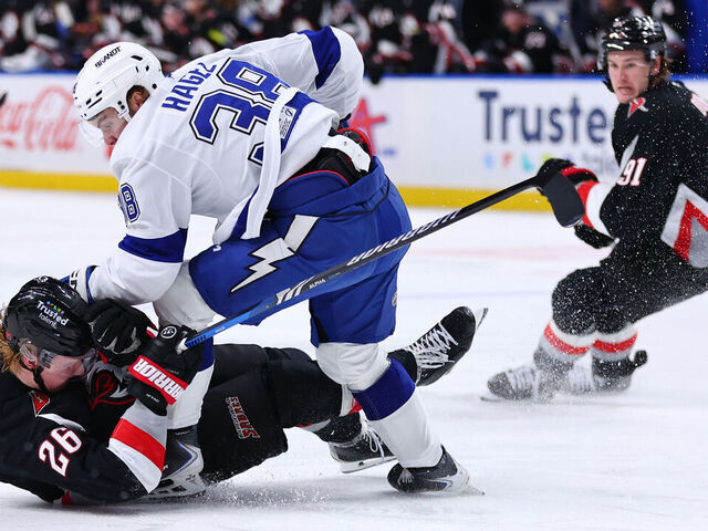 BUFFALO, NEW YORK - MARCH 08: Rasmus Dahlin #26 of the Buffalo Sabres is upset by Brandon Hagel #38 of the Tampa Bay Lightning during an NHL game on March 08, 2026 at KeyBank Center in Buffalo, New York.