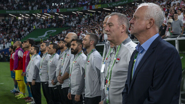 Graham James Arnold, head coach of Iraq, his staff, and substitutes line up prior to the FIFA Arab Cup 2025 Quarter-final match between Jordan and Iraq at Education City Stadium in Doha, Qatar, on December 12, 2025.