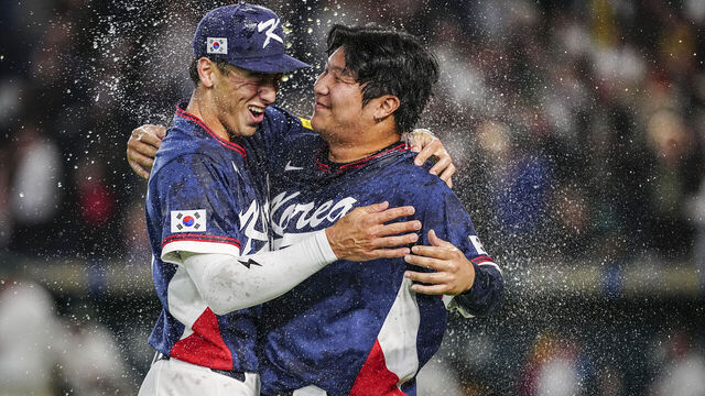 South Korea's Moon Bo-gyeong (R) and Shay Whitcomb celebrate team's victory at the end the World Baseball Classic (WBC) Pool C game between Australia and South Korea at the Tokyo Dome in Tokyo on March 9, 2026.
