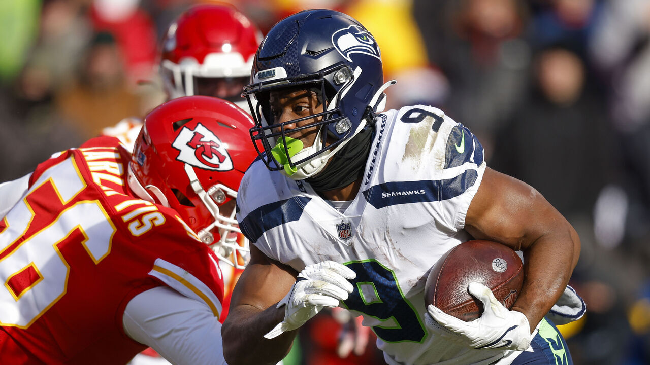 KANSAS CITY, MO - DECEMBER 24: Kenneth Walker III #9 of the Seattle Seahawks runs past George Karlaftis #56 of the Kansas City Chiefs during the second quarter at Arrowhead Stadium on December 24, 2022 in Kansas City, Missouri.