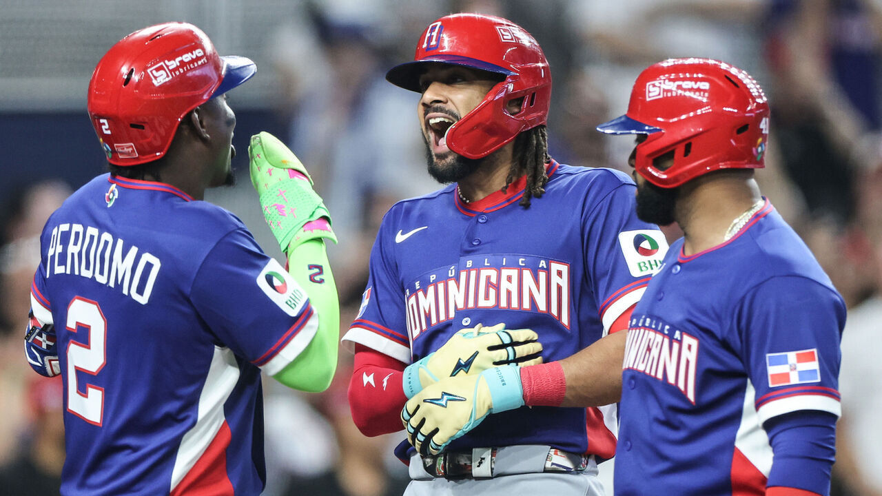 MIAMI, FLORIDA - MARCH 09: Fernando Tatis Jr. #23 of the Dominican Republic reacts with Geraldo Perdomo #2 after hitting a grand slam during the second inning against Israel at loanDepot park on March 09, 2026 in Miami, Florida.