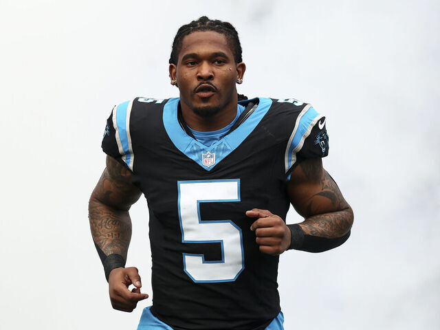 CHARLOTTE, NORTH CAROLINA - JANUARY 10: Rico Dowdle #5 of the Carolina Panthers runs onto the field prior to an NFL wild card playoff football game against the Los Angeles Rams at Bank of America Stadium on January 10, 2026 in Charlotte, North Carolina.