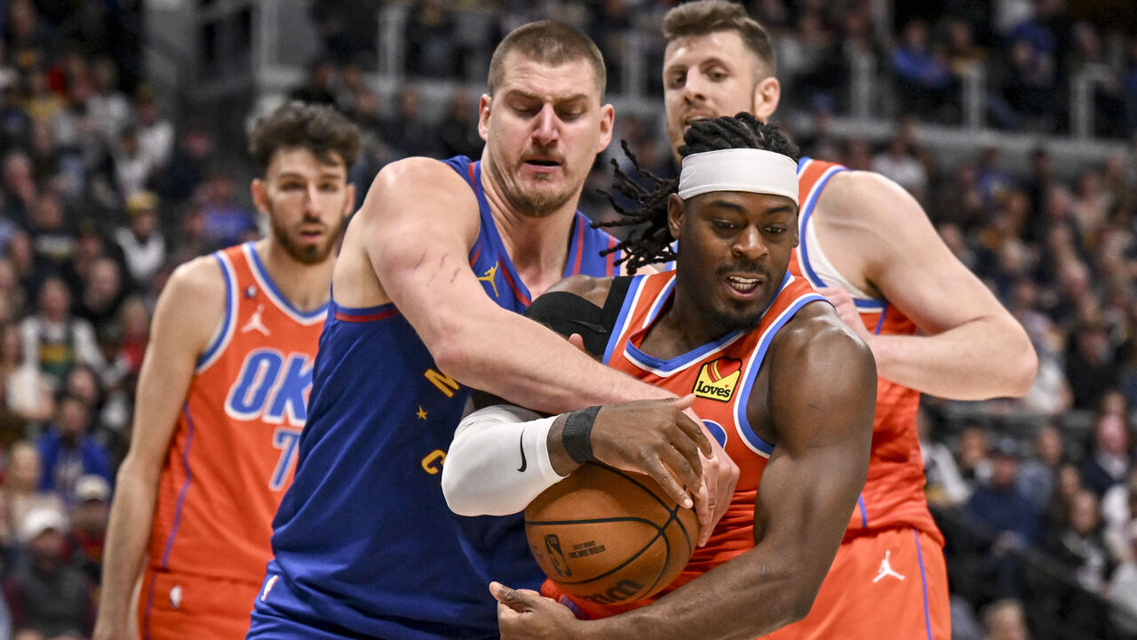 DENVER , CO - FEBRUARY 1: Nikola Jokic (15) of the Denver Nuggets ties up Luguentz Dort (5) of the Oklahoma City Thunder during the fourth quarter of the OKC's 121-111 win at Ball Arena in Denver, Colorado on Sunday, February 1, 2026.