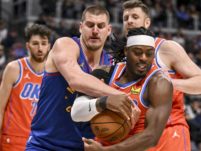 DENVER , CO - FEBRUARY 1: Nikola Jokic (15) of the Denver Nuggets ties up Luguentz Dort (5) of the Oklahoma City Thunder during the fourth quarter of the OKC's 121-111 win at Ball Arena in Denver, Colorado on Sunday, February 1, 2026.