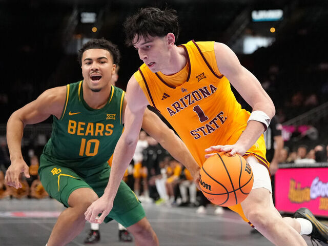 KANSAS CITY, MISSOURI - MARCH 10: Santiago Trouet #1 of the Arizona State Sun Devils drives against Isaac Williams #10 of the Baylor Bears in the first half during the first round game of the Men's 2026 Big 12 Tournament at T-Mobile Center on March 10, 2026 in Kansas City, Missouri.